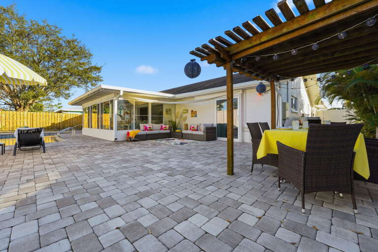 Al fresco dining at its finest! Gather under the charming string-lit pergola for sunset dinners the whole group will remember.