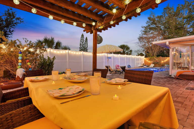 Al fresco dining under the twinkle-lit pergola, just steps from the pool