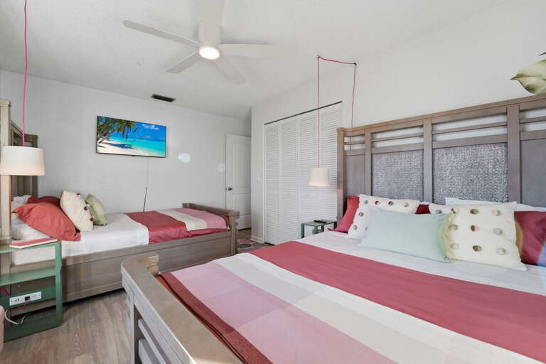 Beach vibes all around! This vibrant twin room blends playful color with comfy queen and twin beds — ideal for family fun and lazy movie nights.