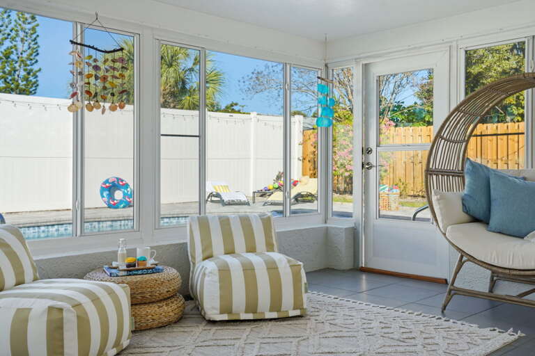 Cabana vibes, no passport required — kick back in the striped loungers with a poolside view