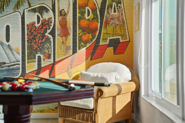 Look closer at the Florida mural — it earns the double-take and makes this the most-photographed corner of the house.