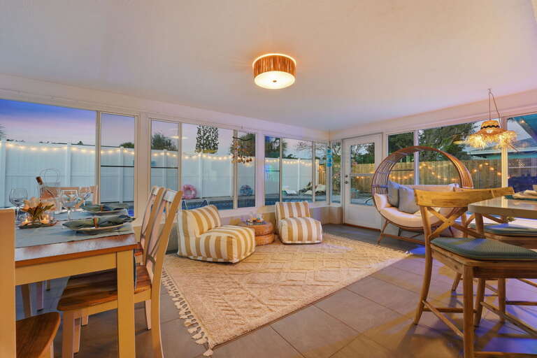 Cozy sunroom seating area overlooking the pool and patio