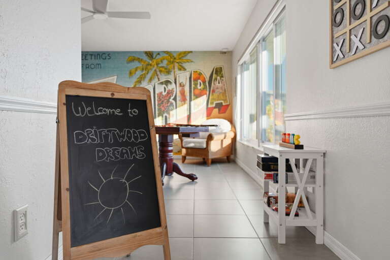 Drop your bags, read the chalkboard at the door, and feel the vacation officially begin — the pool is heated and the game room is ready.