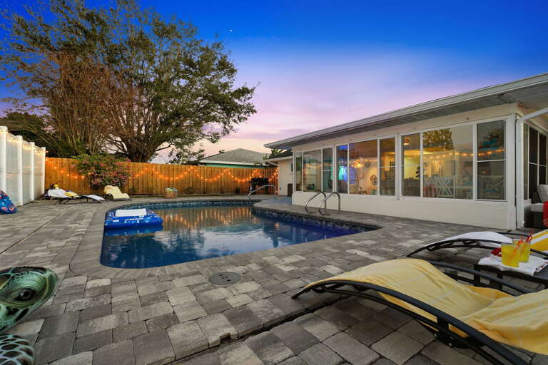 Endless evening vibes! The whole backyard glows as day turns to night — pool, patio, and pergola all lit and ready for you.