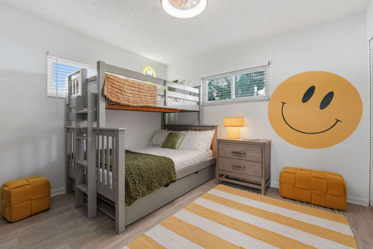 Guaranteed giggles! The kids will love this cheerful bunk room, complete with a giant smiley face and cozy trundle bed for extra sleepers.