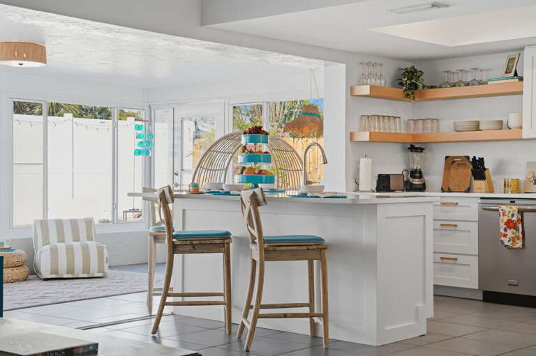 Pour the morning coffee and claim a bar stool — the patio is just through the glass, and the pool is already heated.