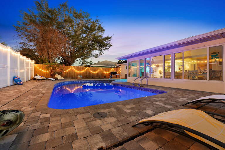 Your private nighttime retreat! Warm glowing lights and a sparkling pool make this backyard the heart of the party after dark.