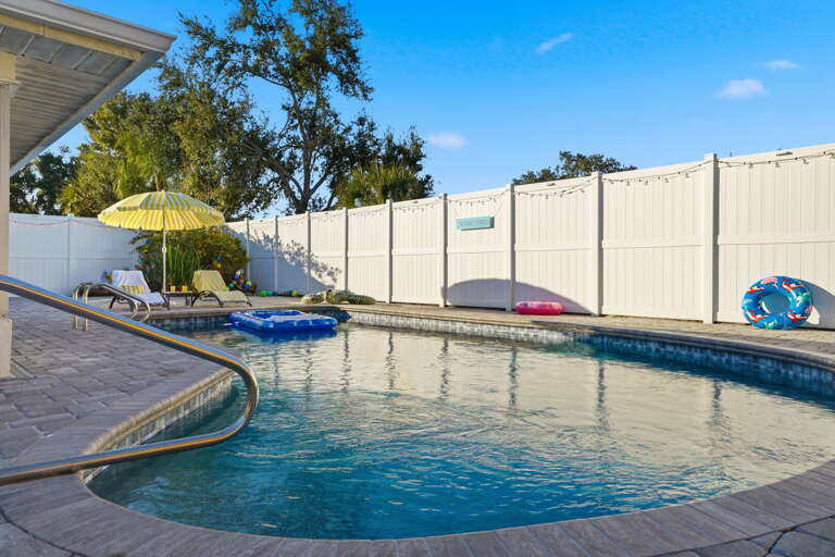 Rise and shine! Sunlight sparkles across the private pool, with floats ready and waiting for a full day of splashing fun.