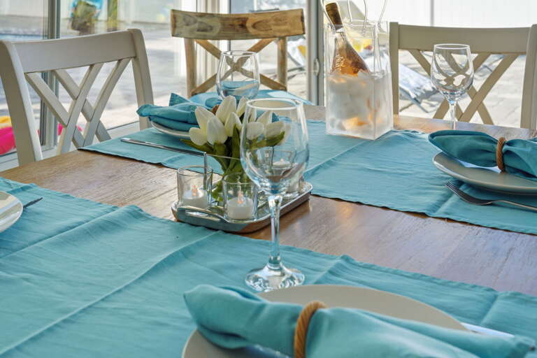 Set out the champagne bucket and pull up every chair — this sunroom turns any dinner into a proper occasion.