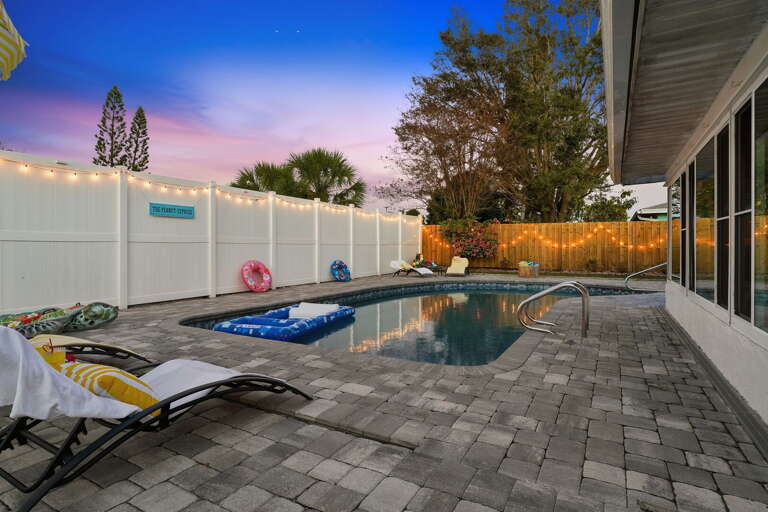 Sparkle and swim! Twinkling lights reflect off the water for a dreamy nighttime pool experience.