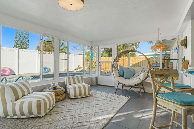The ultimate hangout spot — sunshine, stripes, and a hanging chair calling your name