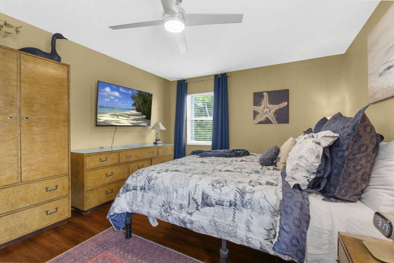 Claim this room, unpack in the armoire, and flip on the wall TV — your coastal master room comes with everything and nothing extra to deal with.