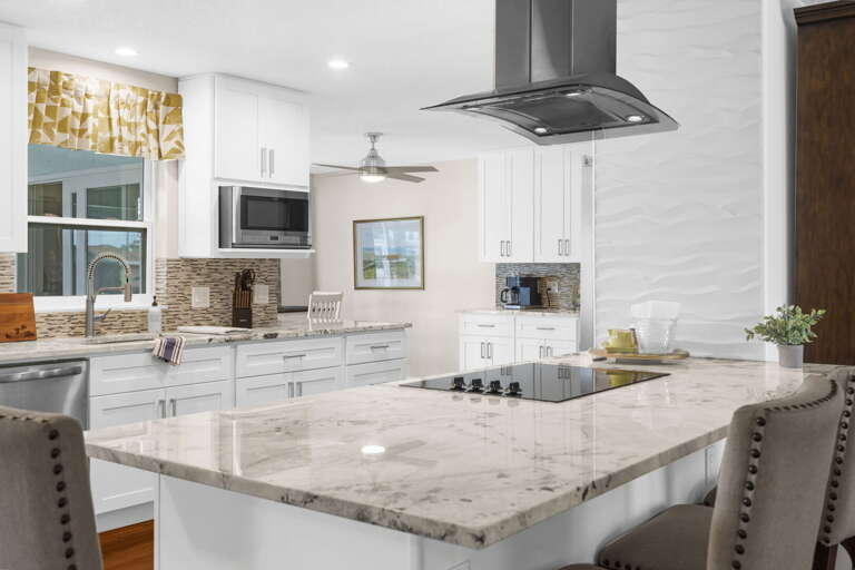 Cook something fresh right off the dock — waterfall quartz island seating, full electric range, and every tool you'll actually need.