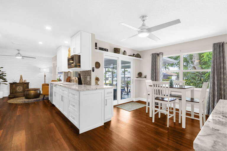 Everything you need for a full week of real cooking — wall oven, electric range, full-size fridge, and island seating for four.