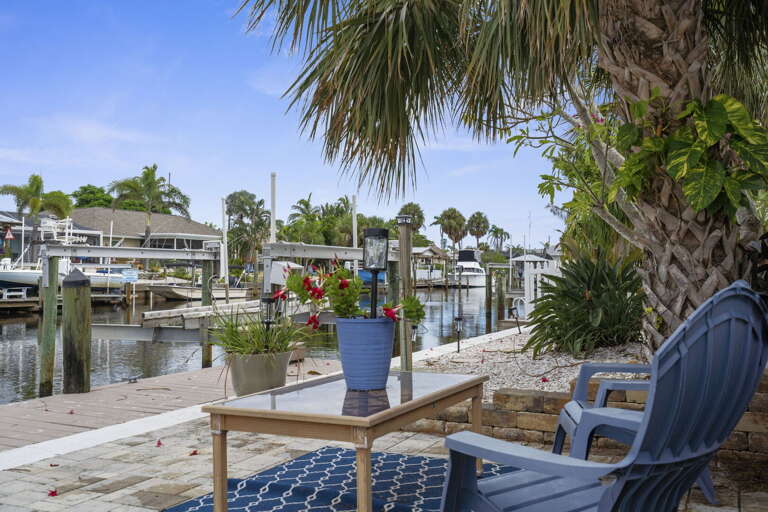 Grab a seat at the edge of your dock and let the canal be the entertainment — calm water, palm shade, and nothing on the schedule.