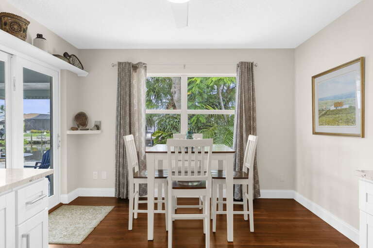 Pull up a white chair and stay for dinner — your dining room seats six with the kitchen right next door for easy serving.
