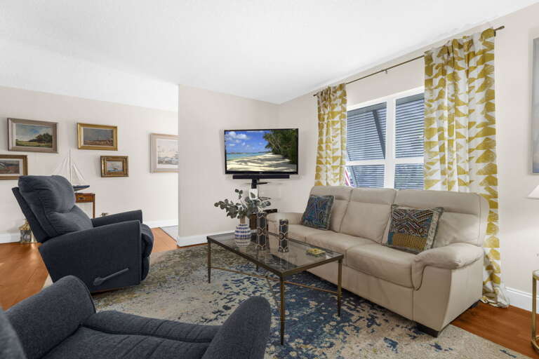 Sink into the sofa after a long day out — navy recliner waiting, TV on, and you're not moving for a while.