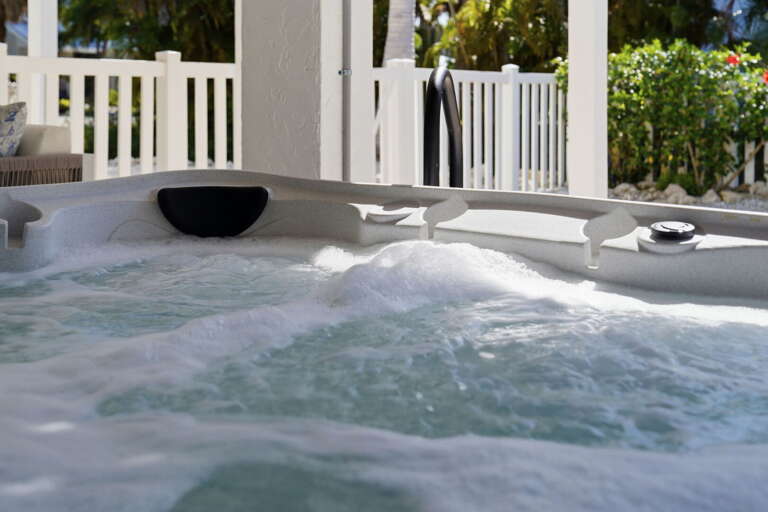 Ease into the hot tub and let the jets do the work — bubbling water and tropical greenery all around you.