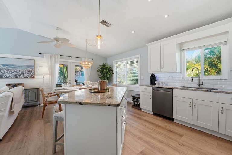 Your open-plan kitchen keeps the cook in the conversation — island flows into dining and living without a wall in sight.