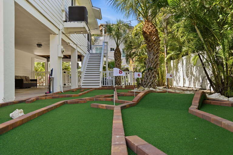 Play all 8 holes on your private mini golf course — it fills the whole backyard and never gets old.