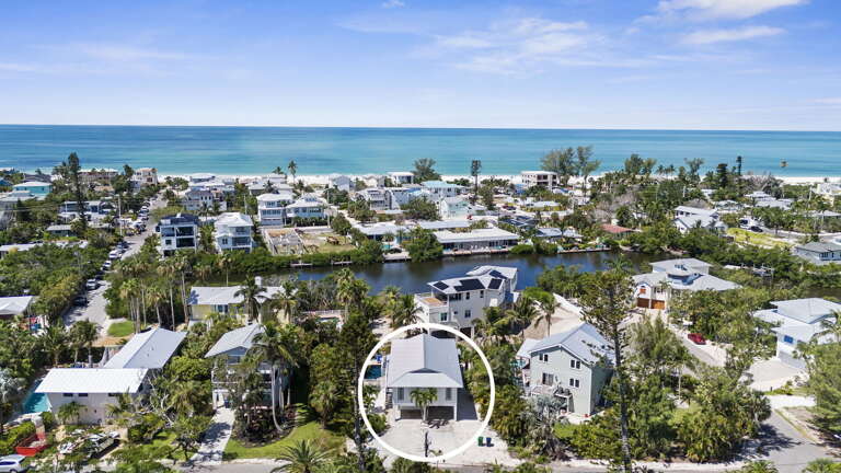 Your property sits in a quiet neighborhood with a canal behind and the Gulf beach just a short walk — see the full picture from above.