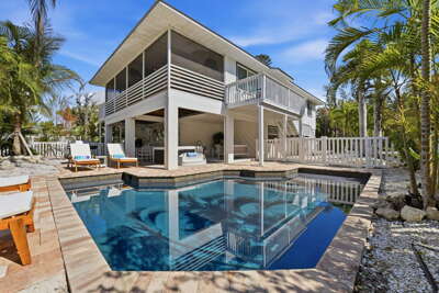 Soak up the sun right outside your back door — heated pool, hot tub, lounge chairs, and swaying palms all yours for the week.