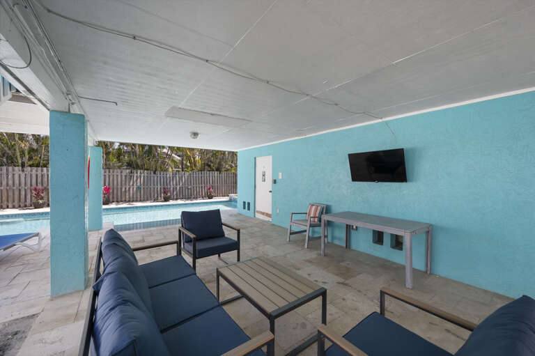 Settle into the shaded lounge right by the pool, switch on the outdoor TV, and call it an afternoon.