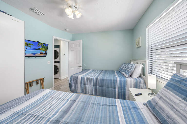 Sleep in the second room wih double beds and toss the beach towels in the washer-dryer right outside the door — fresh by morning.