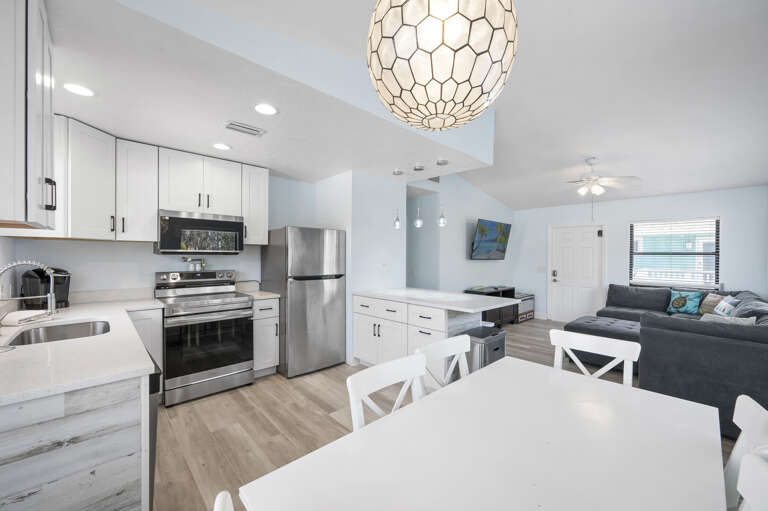 Pull a bar stool up to the island — the kitchen stays part of the conversation no matter where the group is sitting.