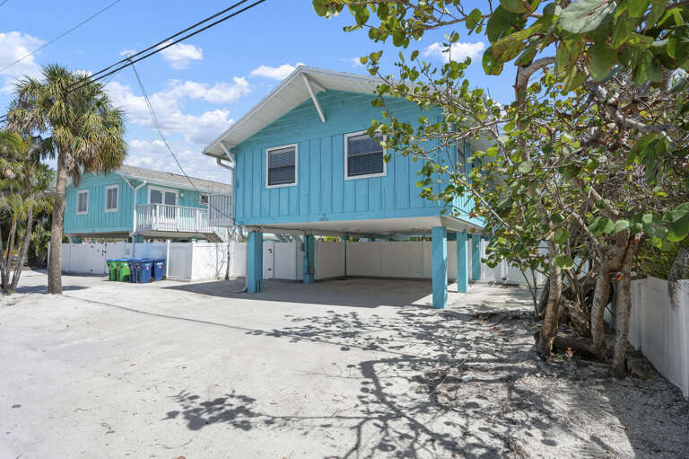 Pull into your shaded parking space under the carport — everything stays covered when you're loading and unloading after a beach run.