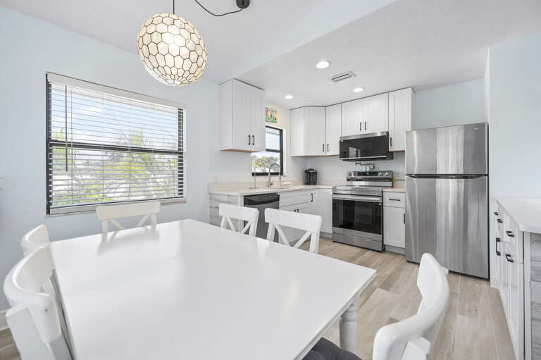 Set dinner on the table ten seconds after it leaves the stove — kitchen and dining are that close. Post-beach evenings are easy here.