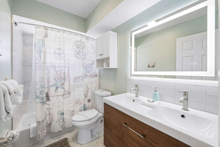 Step into a clean, well-lit bathroom with tub/shower combo and LED vanity mirror. Rinse off the sand, get ready for dinner, out in ten minutes.