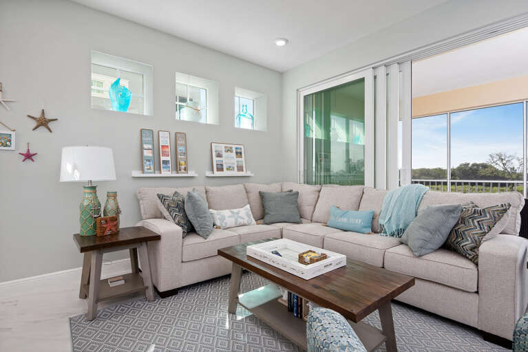 Gather the whole group in the open living room — bay views through every window, plenty of seating for seven.