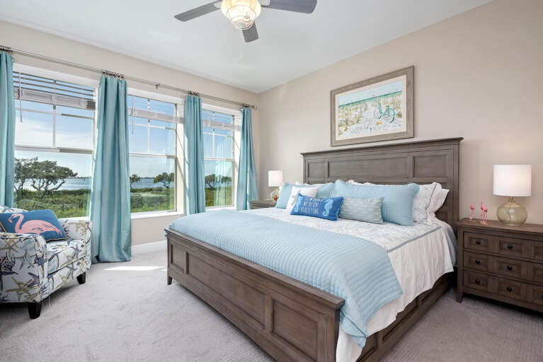 Wake up to shimmering bay views from your king master suite — sunset over the water is your clock.