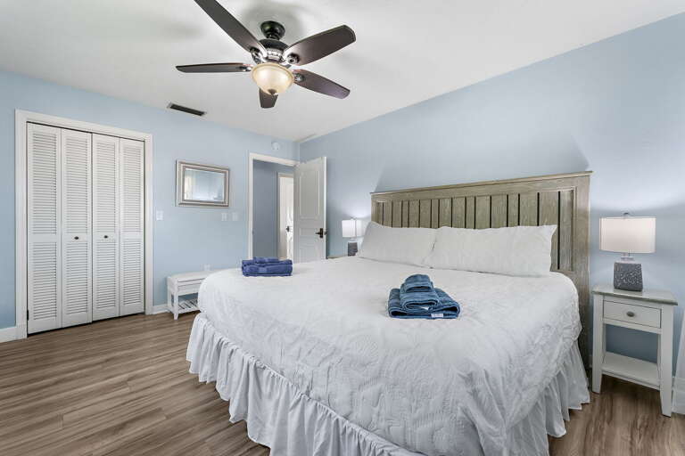 Find your quiet room at the end of the hall — King bed, plantation shutters, away from the main action.