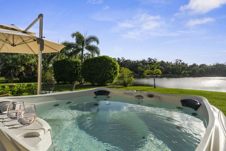 Float in the hot tub with the lake spread out below you — daylight version of the night-swim moment, equally good.