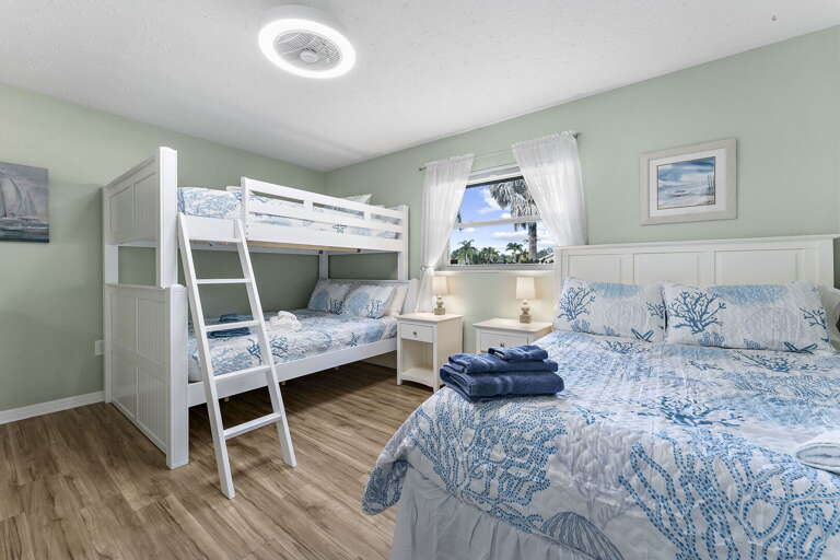 Your kids fight over which bed they get — bunk plus queen, blue coral bedding, room for cousins and stuffed animals to spare.
