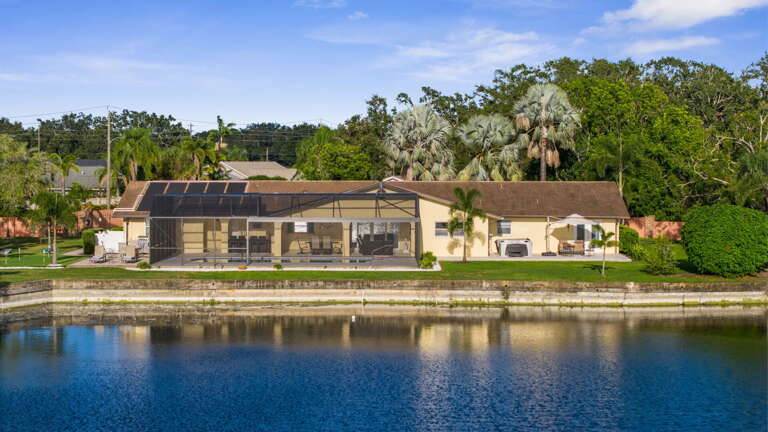 From across the lake you can see what guests rarely get — your house, your pool, your green, your acre.