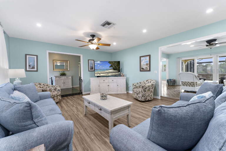 Take in the open-plan living from the back corner — sightlines straight to the kitchen and out to the lake.
