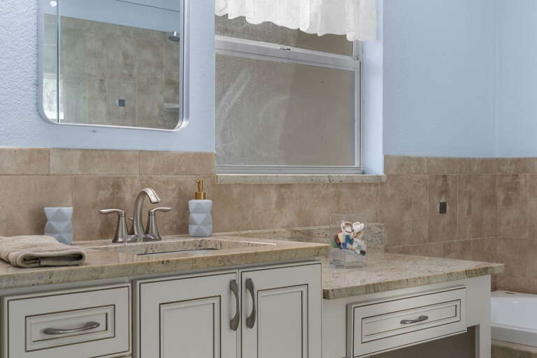 Run your hand over the travertine backsplash in the en-suite — the finish details you notice on day two.