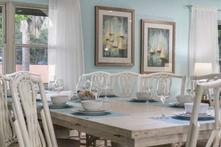 Set your table for the welcome dinner — wine glasses already poured, placemats down, everyone sits.