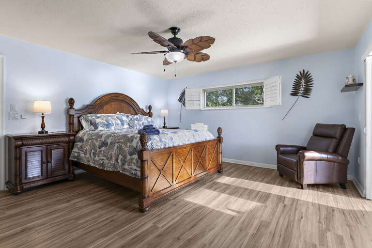 Where you will sleep harder than you have in months — carved frame, soft bedding, lake breeze through the patio door, alarm strictly optional.