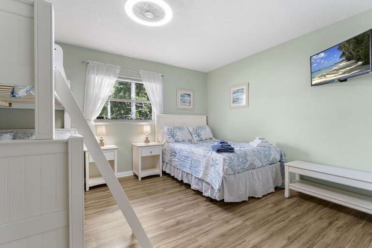 Watch the kids claim the bunks before the adults finish unloading — wall TV for movie night right there.