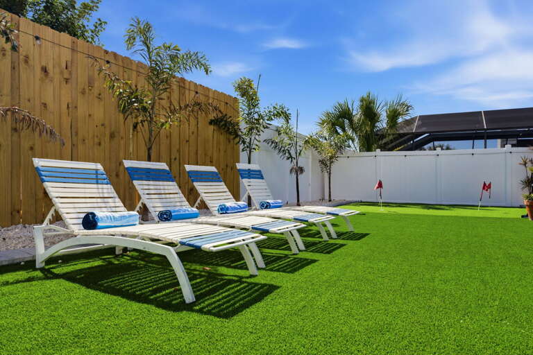 Claim a chaise lounge on the artificial turf and soak up the Florida sun — the privacy fence keeps the afternoon all to yourself.