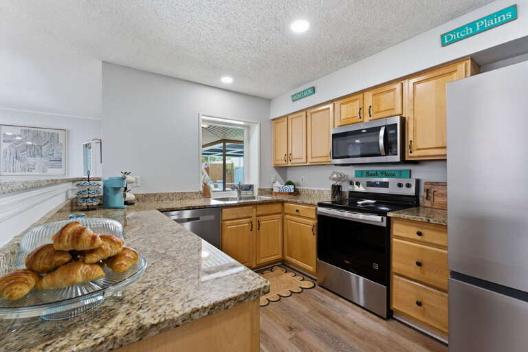 Cook a full family breakfast at the granite island — plenty of counter space and stainless appliances for every dish you're planning.