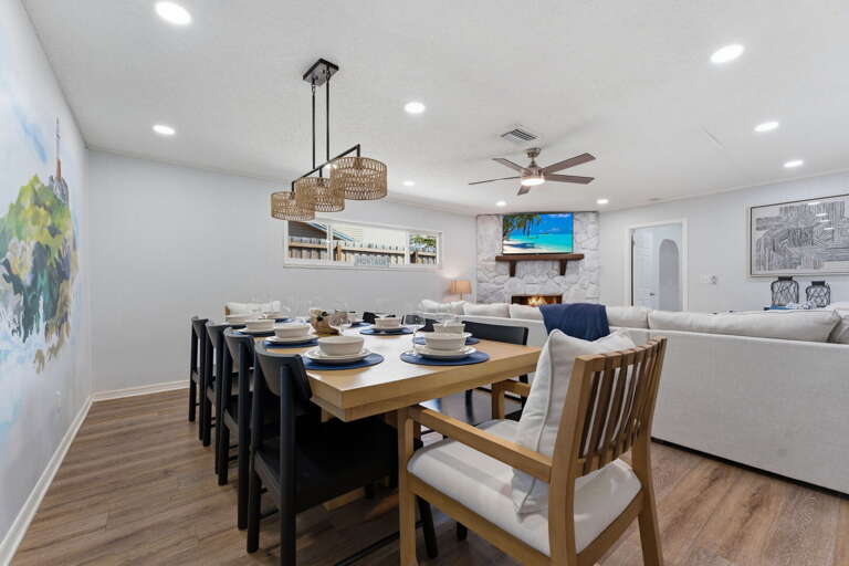 Gather at the full dining table and let dinner run as long as it needs to — the space holds the whole group with room to spare.
