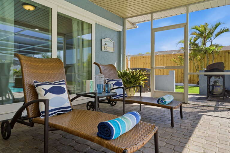 Lounge poolside with your towel and a good book — the screened enclosure keeps things peaceful from morning to night.