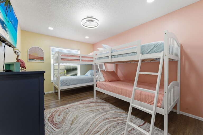 Put the little ones in the bunk bed room and let them argue over who gets the top — the full-twin bunk is built for childhood adventures.