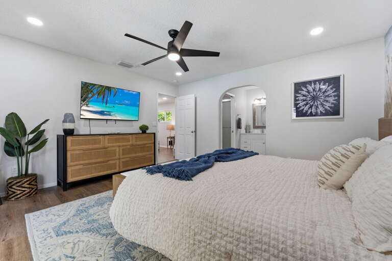 Step through the living room into a king bedroom tucked away from the rest of the house — perfect for the couple wanting their own corner.