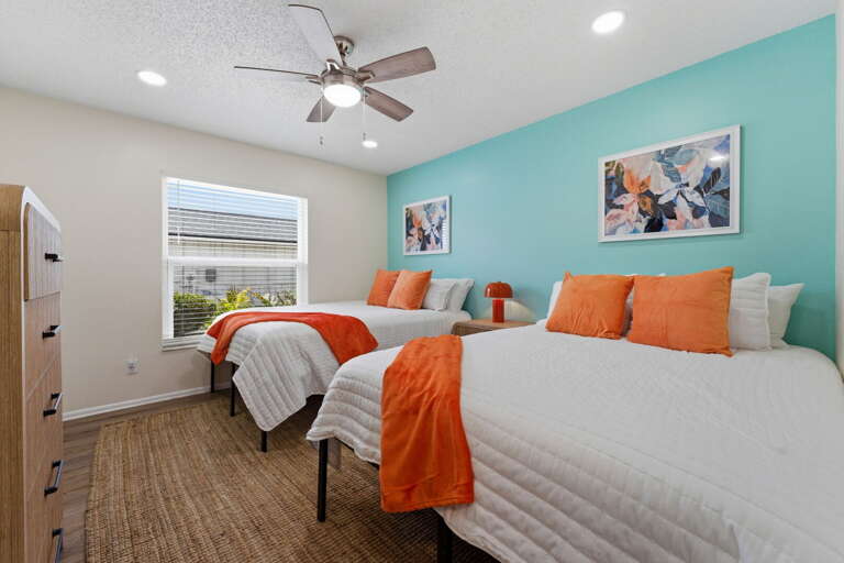 Tuck the littles into their twin beds with the teal accent wall holding court — kids always claim this room the moment they walk in.